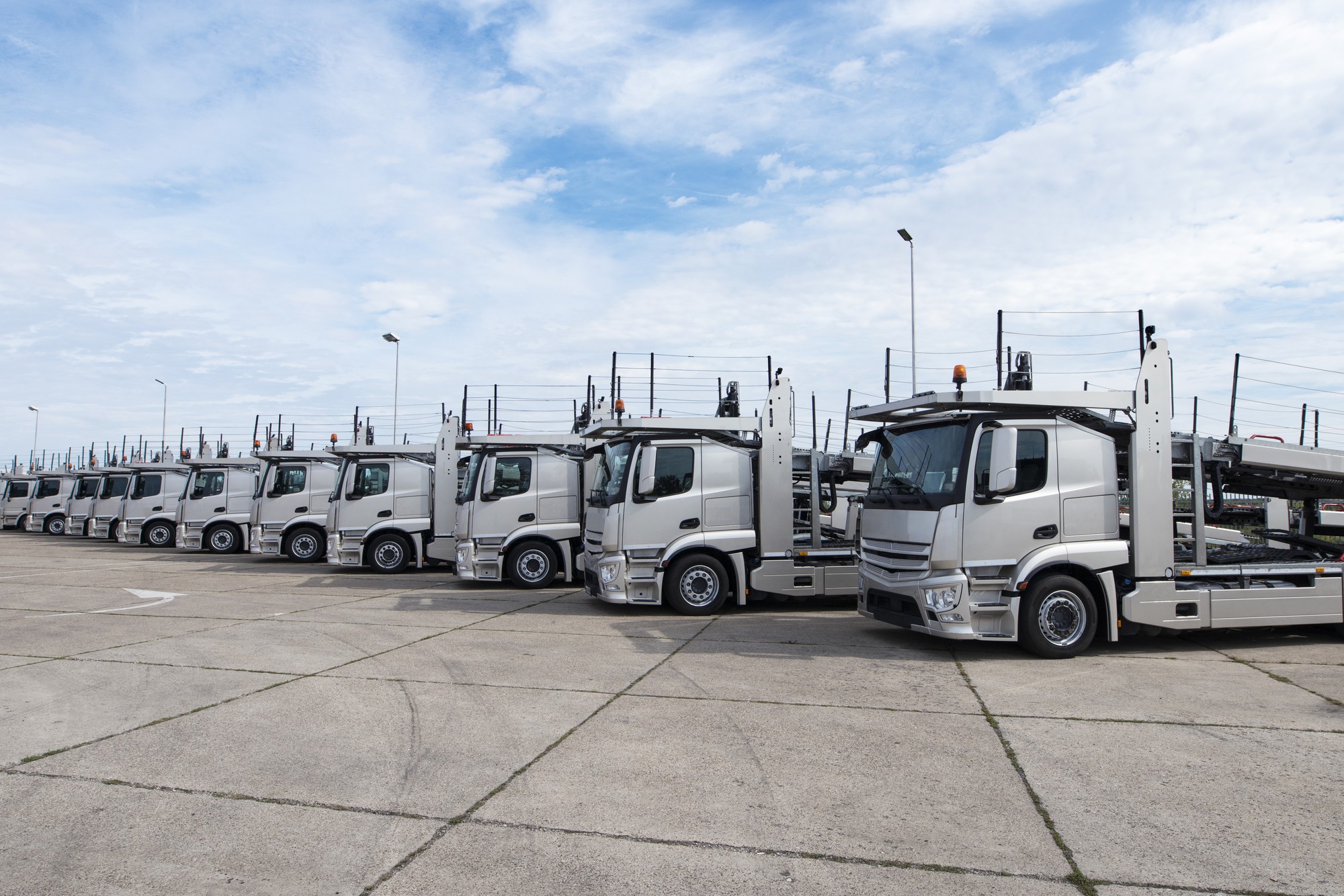 Fleet of delivery trucks parked in logistics yard